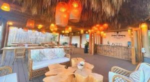a patio with tables and chairs and a restaurant at Stratus Resort in Khao Kho