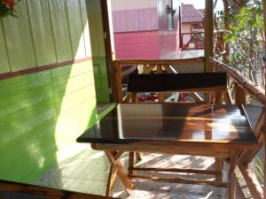 a table and chairs on a porch of a house at Na Chan Resort in Ban Khlong Khlung (1)