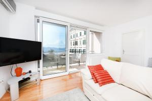 a white living room with a white couch and a large window at Jelena - Spacious Sea View Apartment - Old Town Zadar in Zadar