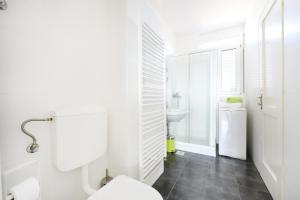 a white bathroom with a toilet and a sink at Jelena - Spacious Sea View Apartment - Old Town Zadar in Zadar +22 photos