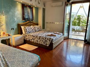 a bedroom with a bed and a large window at B&B Garda 4U in Desenzano del Garda +98 photos
