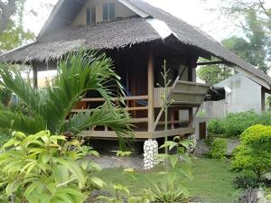 a small house with a thatch roof at Mayas Native Garden Resort in Basdiot