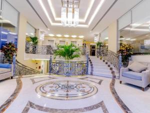a lobby with a staircase with blue railing at Gulf Pearls Hotel in Doha +84 photos