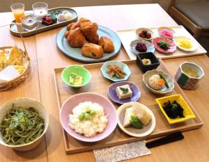 a table topped with plates of food and bowls of food at Almont Hotel Kyoto in Kyoto +26 photos