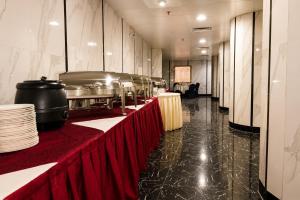 a long row of tables in a restaurant with red table cloth at Maysan Al Safa Hotel in Mecca