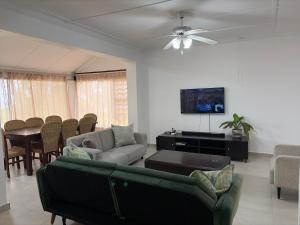 a living room with a couch and a table at 2 bedrooms Ngubelanga Stays in Margate