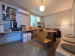 an office with a desk and chairs and a table at 고요스테이 in Chuncheon