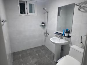 a white bathroom with a sink and a toilet at 고요스테이 in Chuncheon +6 photos