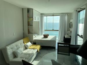 a living room with a couch and a bed at Loft da Prainha in Arraial do Cabo +37 photos