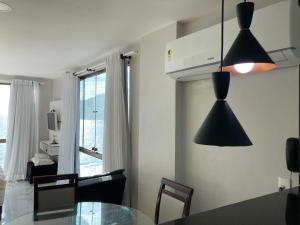 a kitchen with a table and a dining room at Loft da Prainha in Arraial do Cabo