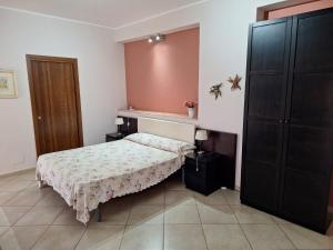 a small bedroom with a bed and a closet at Appartamenti Sole delle Aci in Aci SantʼAntonio