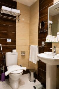 a bathroom with a toilet and a sink at Maysan Al Safa Hotel in Mecca +16 photos