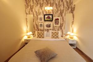a bedroom with a large bed with two lamps at Shalom in Colva