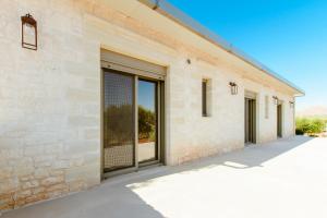 a building with large glass doors on the side at Sky And Stone Private Villa in Kathiana
