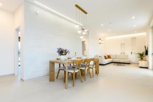 a dining room and living room with a table and chairs at Sky And Stone Private Villa in Kathiana +75 photos