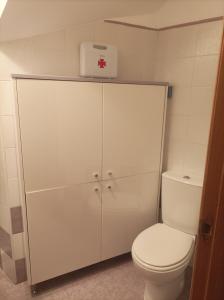 a bathroom with a toilet and a white cabinet at La Vega in Cardeñadijo +17 photos