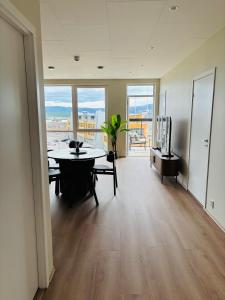 a living room with a table and a large window at Arctic Privé Panorama Residence Alta in Alta