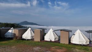a row of tents with the ocean in the background at Heaven Khaokho (เฮฟเว่น) in Khao Kho