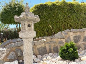 a stone cross in front of a stone wall at Ferienwohnung Fuchs in Roding