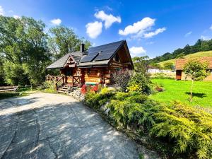 a log cabin with a road in front of it at Szepit in Lutowiska