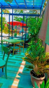 a patio with tables and chairs and plants at Sunset Beach Retreat & Beach Bistro in Batu Ferringhi +11 photos