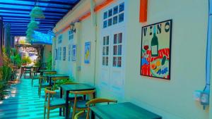 a row of tables and chairs in a restaurant at Sunset Beach Retreat & Beach Bistro in Batu Ferringhi