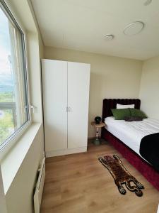 a bedroom with a bed and a large window at Arctic Privé Panorama Residence Alta in Alta