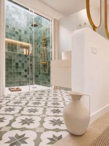 a bathroom with a shower and a vase on the floor at Gándara Lodge Luxury in Tijoco de Abajo