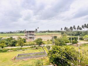 an old building in the middle of a field at Hampi Icon Palace in New Hampi +23 photos