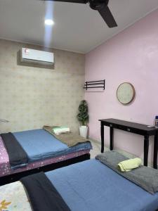 a room with two bunk beds and a table at Homestay D Makmur UNIT 2 in Mersing +15 photos