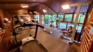 a gym with several exercise bikes and a treadmill at Hotel Jardín de Aura in Muros de Nalón
