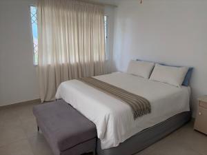a bedroom with a large white bed and a window at 2 bedrooms Ngubelanga Stays in Margate