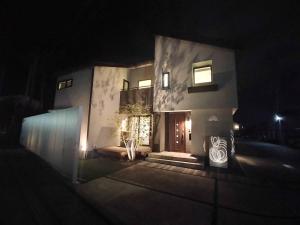 a house with a front door at night at マークヴィラスイート in Shimo-suwa