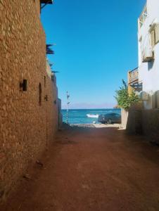 an alley with a view of the ocean at Quiet place in Dahab