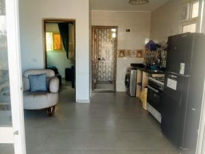 a kitchen with a refrigerator and a chair in a room at Quiet place in Dahab