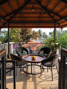 a patio with a table and chairs on a balcony at The Elegant homes in Kushālnagar
