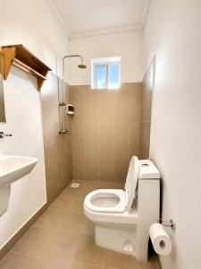 a bathroom with a toilet and a sink at Kendwa Crystal Coast Hotel in Kendwa +100 photos