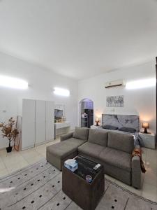 a living room with a couch and a table at Towaya studio in Al Ain