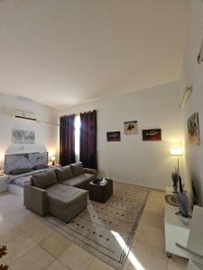 a living room with a couch and a bed at Towaya studio in Al Ain