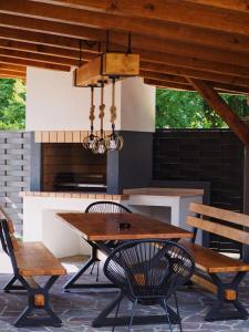 a table and chairs on a patio with a fireplace at Villa Pika in Delnice