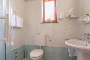 a bathroom with a toilet and a sink at B&B Vila Milčetić in Malinska +27 photos