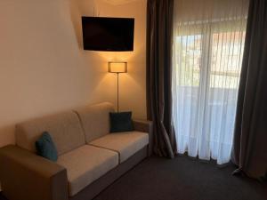a living room with a couch in front of a window at B&B Vila Milčetić in Malinska