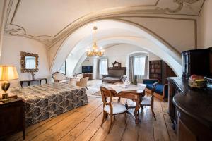 a bedroom with a bed and a table and chairs at Chateau GrandCastle in Liptovský Hrádok