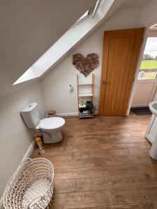 a bathroom with a toilet and a staircase with a stair at Room with a View in Aldergrove +22 photos
