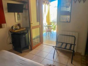 a bedroom with a bed and a door to a patio at Guesthouse Nuvole in Olbia