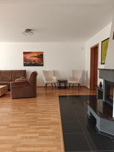 a living room with a couch and a fireplace at MaMa Apartment in Seredʼ +15 photos
