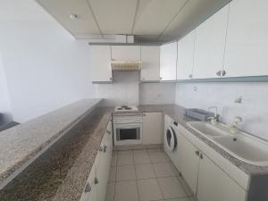a white kitchen with a sink and a stove at Chalet 1BR 1BA with Beach&Pool&Tennis&Basketball in Jounieh