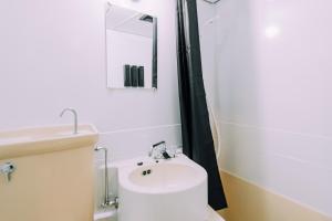 a bathroom with a white toilet and a sink at Work Ready Stay - Quiet Nakasu 202 in Fukuoka +43 photos