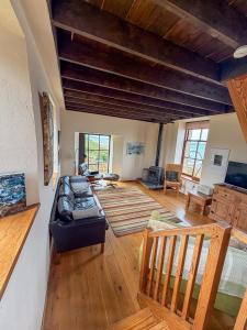 a living room with a couch and wooden floors at The Mill O Cara in Orkney