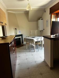 a kitchen with a table and chairs in a room at B&b La Casa di Michela in Castelmezzano